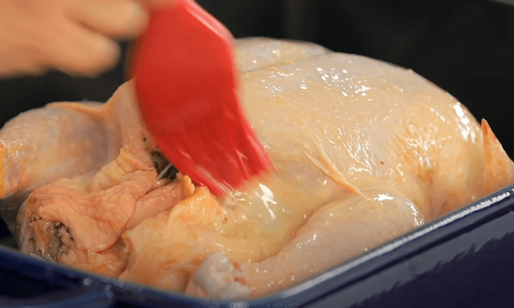 melt two tablespoons of unsalted butter and brush the chicken all over the top and sides