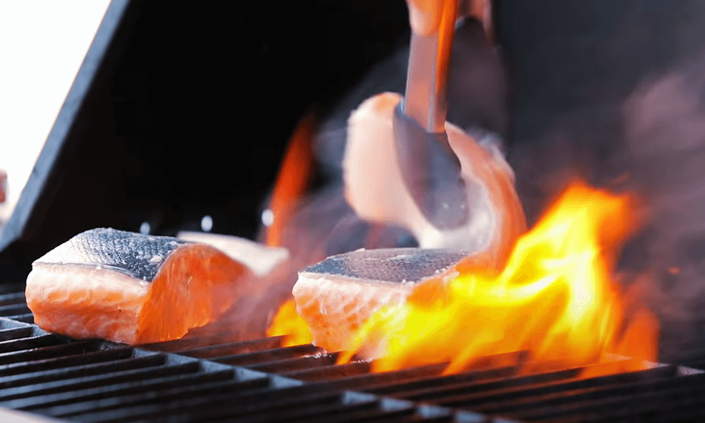 place the salmon onto the hot grill skin